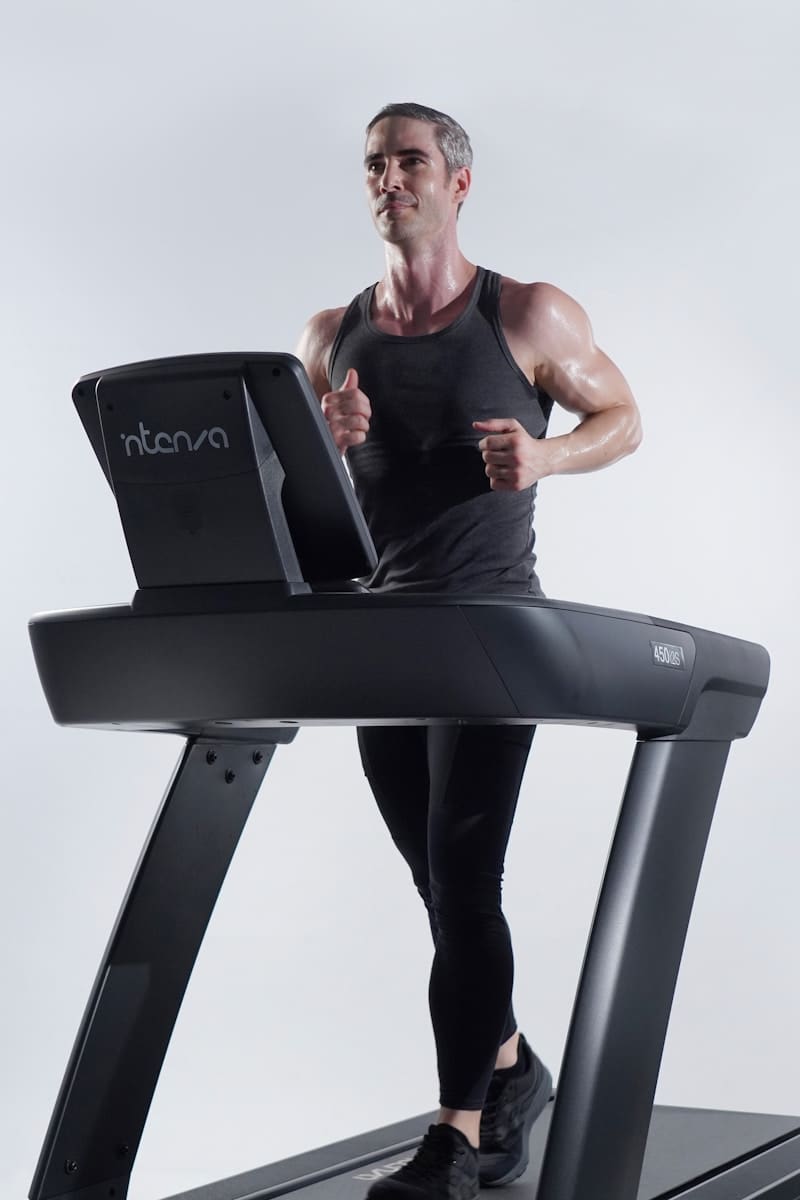 a man on a treadmill with a laptop