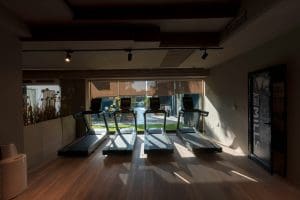 a room with a treadmill and a large window