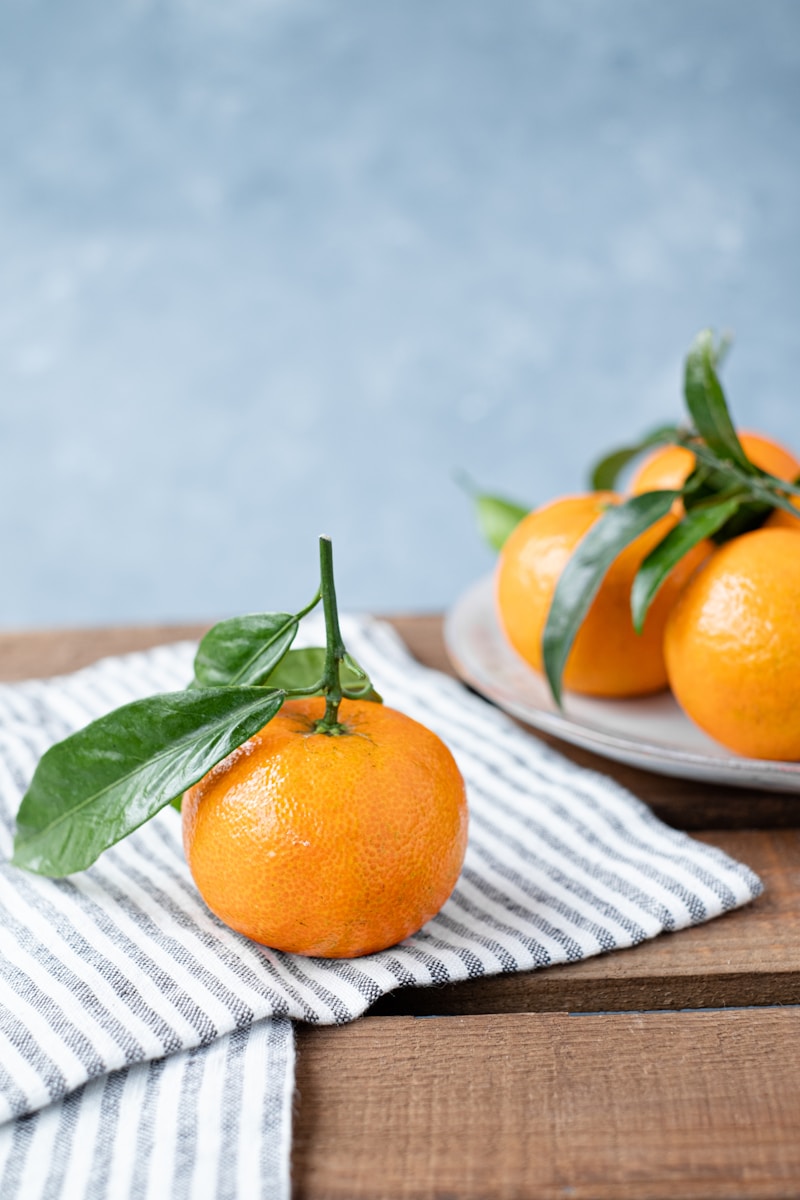 orange fruit on white table cloth