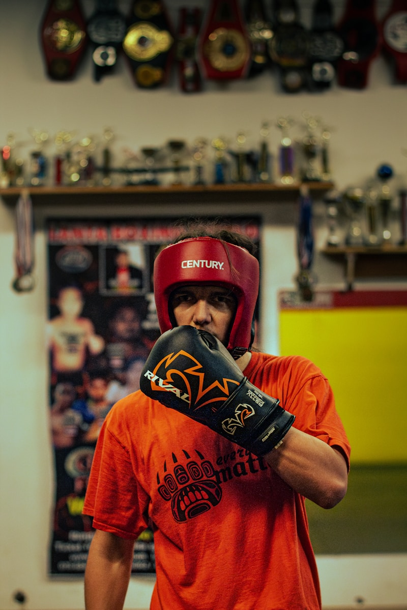 a man wearing a red helmet and boxing gloves