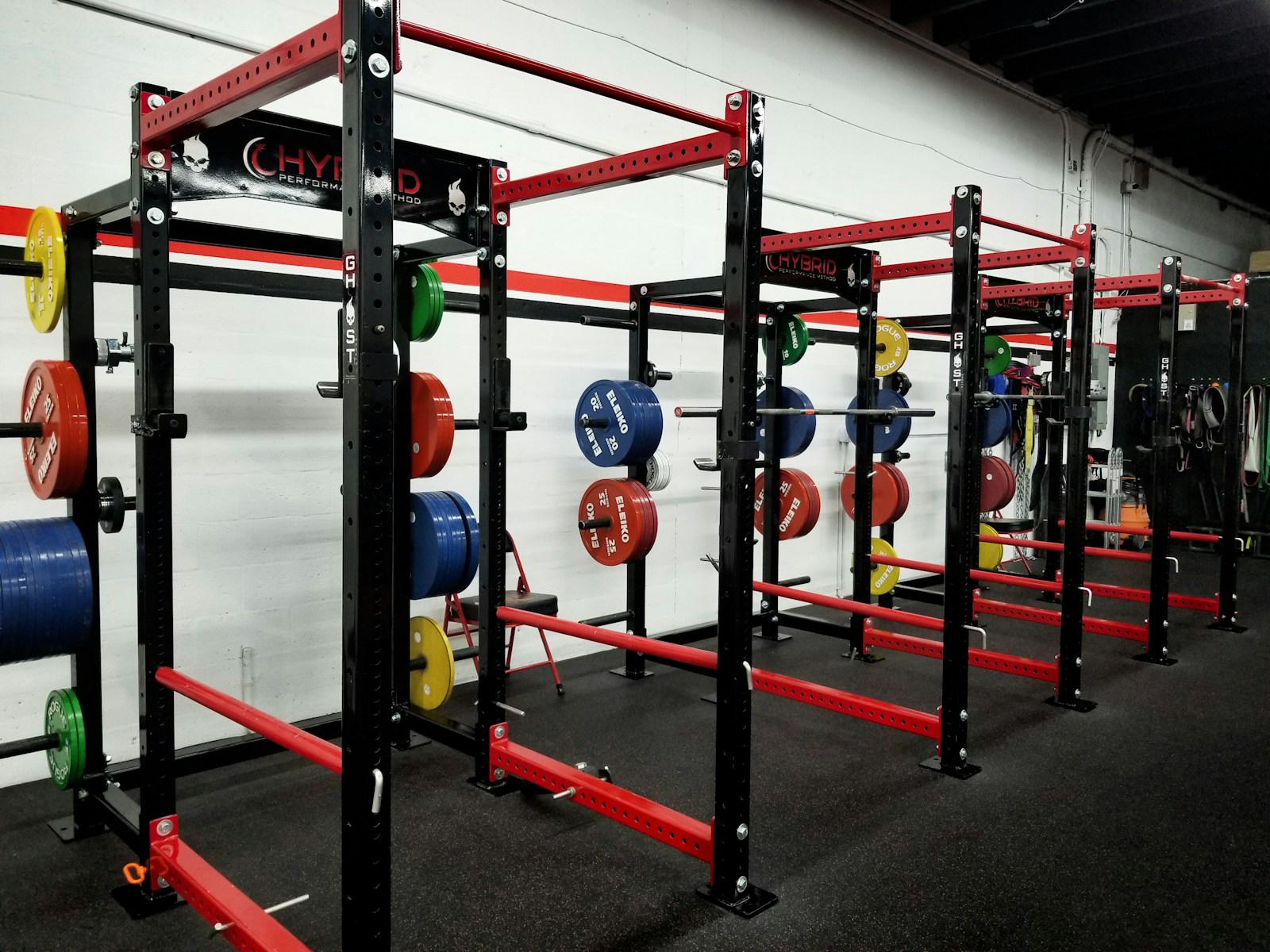 three red barbell machines
